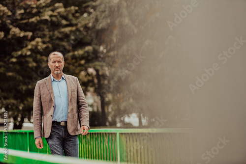 Focused businessman in a suit walking in the park