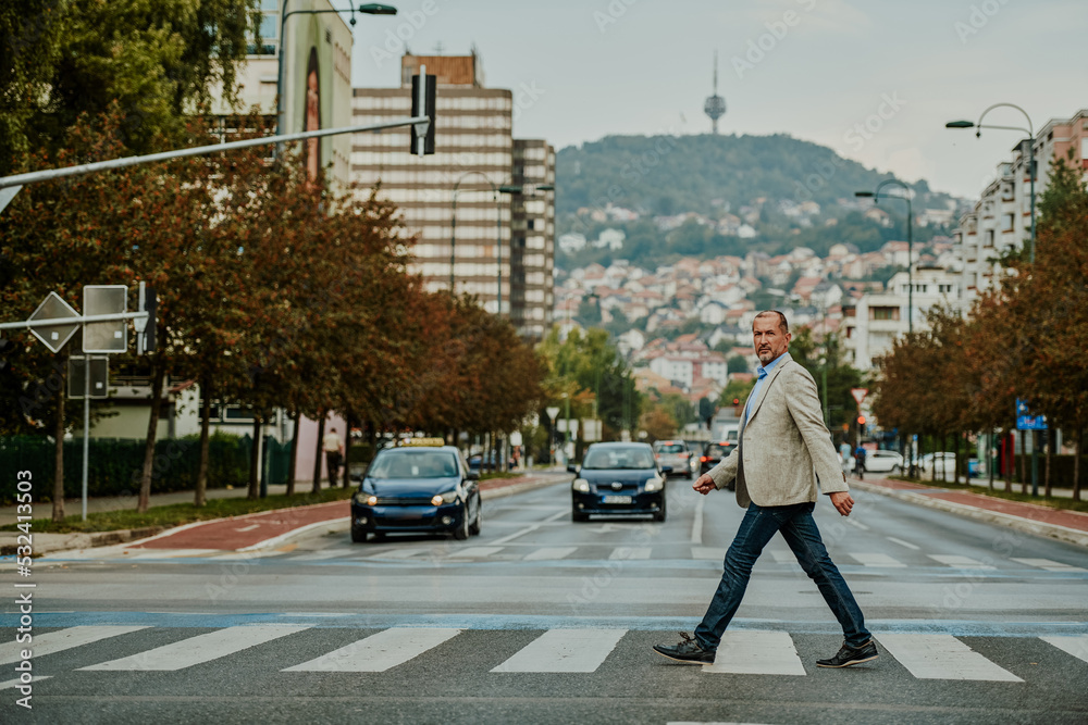 focused businessman in suit walking in urban environment.