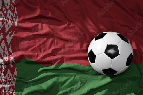 vintage football ball on the waveing national flag of belarus background. 3D illustration