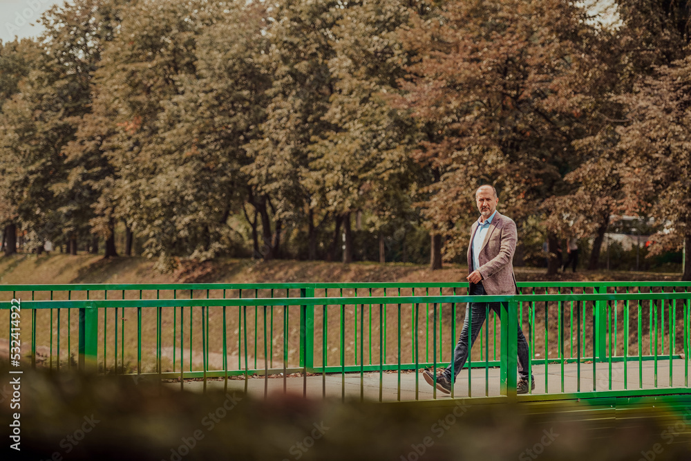 focused businessman in suit walking in urban environment. focused businessman in suit walking in urban environment.