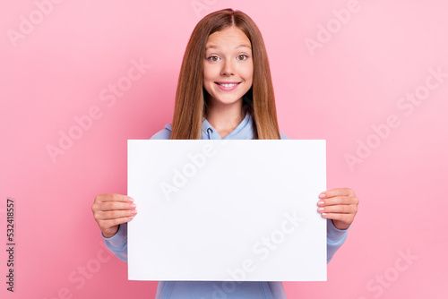 Photo of young small pretty nice cute girlish lady school learner wear blue sweater toothy smile hold paper placard ad isolated on pink color background