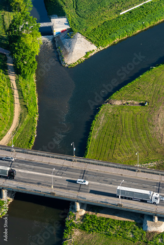 Aerial view of a bridge over a river with several cars in the morning on a summer day photo