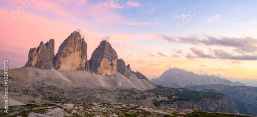 Stunning panoramic view of the Three Peaks of Lavaredo   Tre cime di Lavaredo  Mount Paterno and a refuge during a beautiful sunset