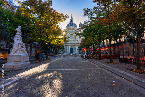 Facade of the Sorbonne University building surrounded by trees in the colors of autumn, Paris. France