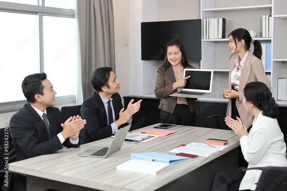 Collaborative process of professional businesspeople going over on new project, using paperwork and computer presentation with brainstorming ideas, coworker and work together at office meeting concept