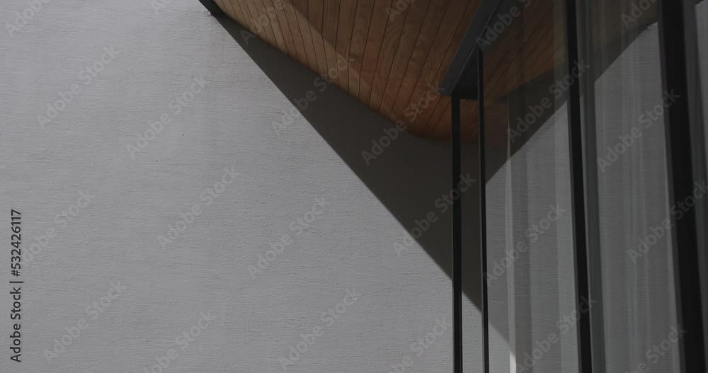 4K video cement clean wall with movement natural shadow with wooden ceiling.