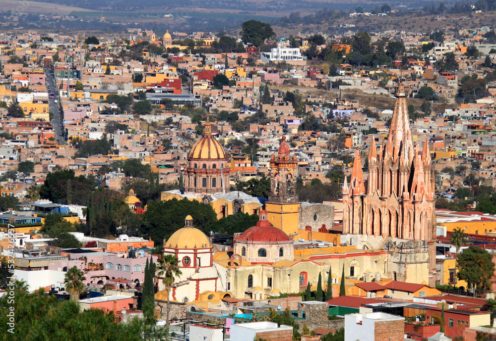 Ancient towers of San Rafael and San Miguel Arcangel cathedrals. Panoramic view of the historical old town of San Miguel de Allende in Mexico. Colorful, traditional colonial downtown neighborhood.