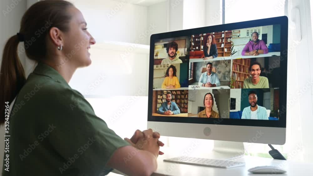 Side view female entrepreneur using computer app for video call sitting in home office, young woman involved in video conference, watching educational classes at home