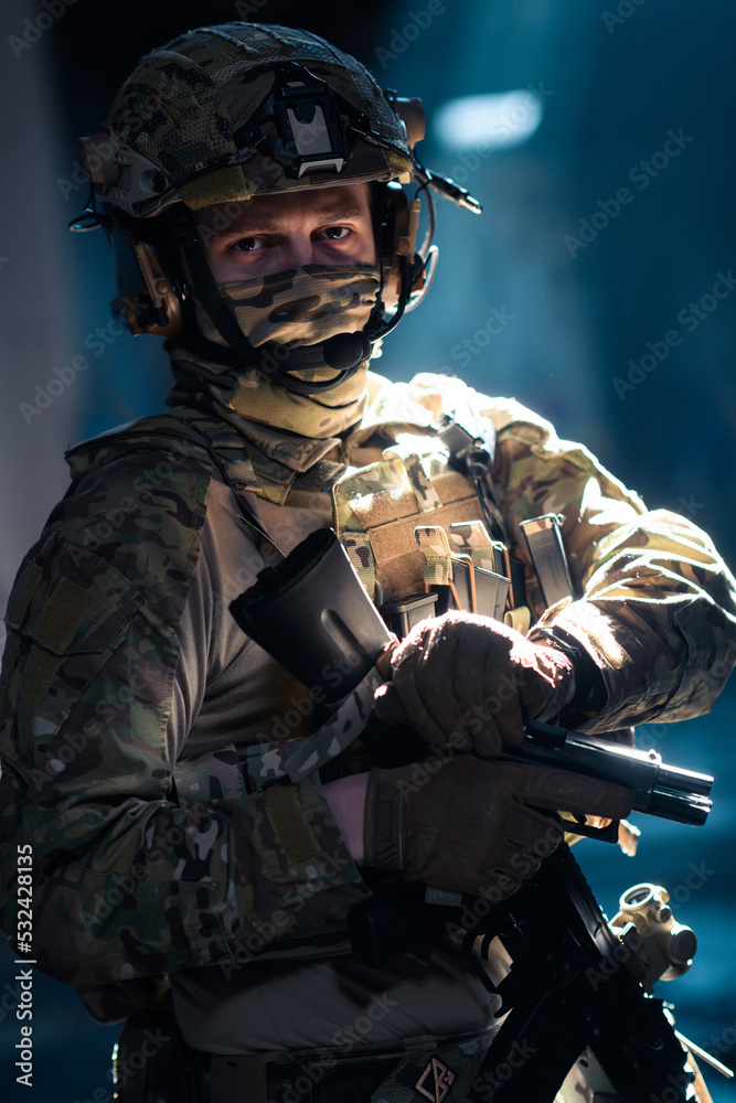 Soldier of army elite forces, special security service fighter with hidden behind mask and glasses face, in helmet and load carriage system, aiming with service pistol low key. Soldier of army elite forces, special security service fighter with hidden behind mask and glasses face, in helmet and load carriage system, aiming with service pistol low key.