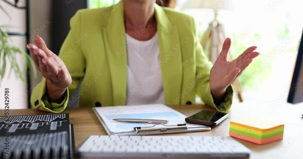 Gesticulating with hands of talking woman sitting at table Gesticulating with hands of talking woman sitting at table