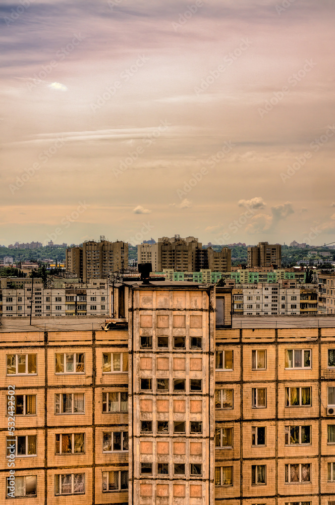 Big pink clouds in the sky over high buildings in the Obolon district of Kiev, Ukraine, near the Minska metro station.