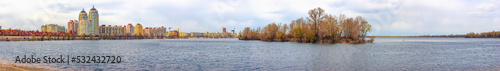 A view of the Dnieper river close to Obolonska Naberezhna in the Obolon district of Kiev  Ukraine  during a cold winter day. Buildings appear in the distance