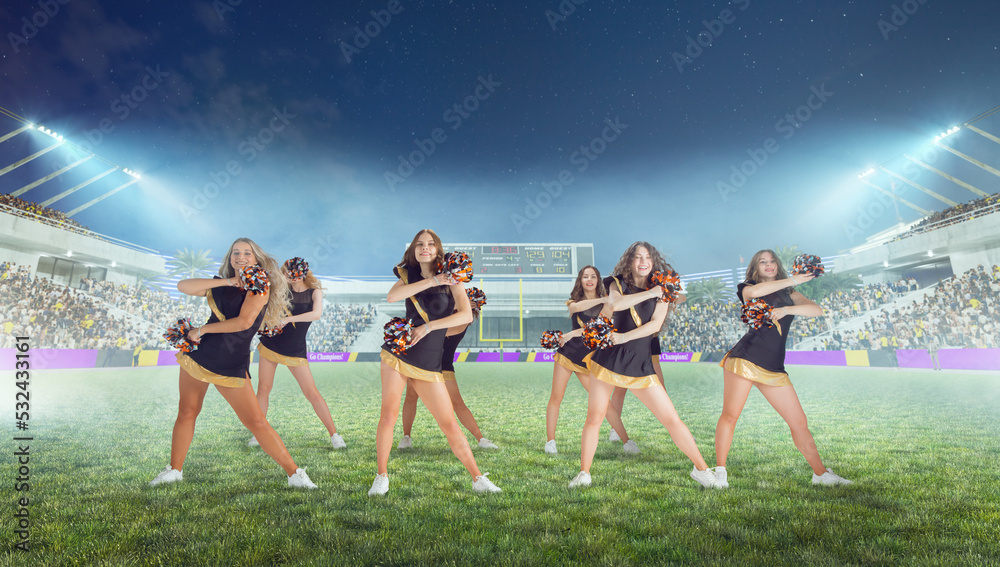 Obraz premium Group of cheerleaders in action on stadium in night