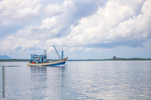 Fishing boat in perfect cloud and ocean in the sunny day