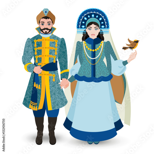 Newlyweds. A young couple in rich Slavic costumes. A girl in a kokoshnik with a veil holds a man's hand. Historical costume. Fashion.