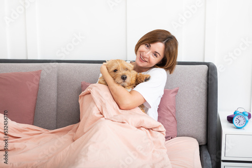 Wallpaper Mural Young and beautiful woman lying in the bed and hugging her adorable pet dog. Perfect friendship concept	 Torontodigital.ca
