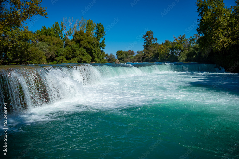 Fototapeta premium Beautiful natural landmark of manavgat waterfall with waterfall lake landscape near Manavgat city, Turkey