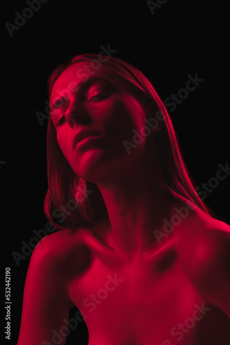 Passion. Dark red night. Young sensual woman in neon light on dark background. Cyberpunk style, beauty, halloween concept.