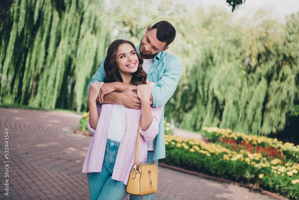 Photo of cute pretty husband wife dressed casual clothes walking embracing enjoying sunshine outside backyard Photo of cute pretty husband wife dressed casual clothes walking embracing enjoying sunshine outside backyard