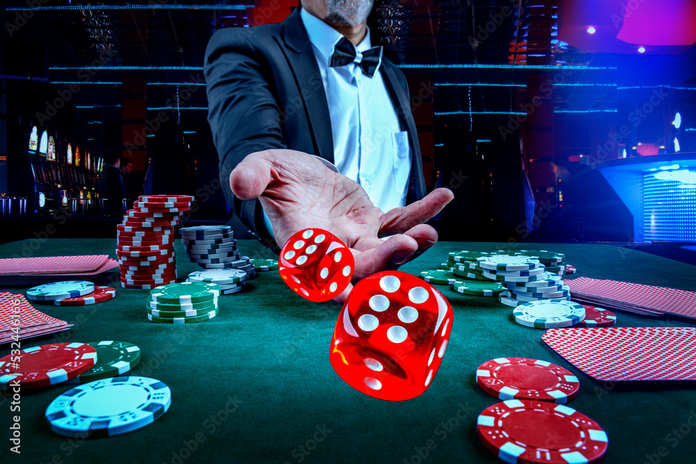 Gambling concept. Close up of male hand throwing dice at casino, gambling  club. Сasino chips or Casino tokens, poker cards, gambling man spending  time in games of chance Photos | Adobe Stock