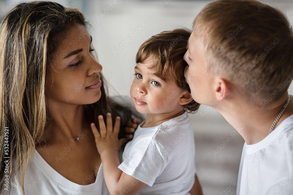 a friendly happy family, parents playing with a small child. a friendly happy family, parents playing with a small child.