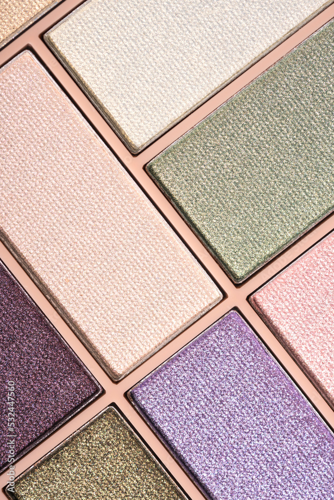 Fototapeta premium Glitter eyeshadows palette for festive makeup as background. Professional make up and beauty concept, flat lay. Vertical image