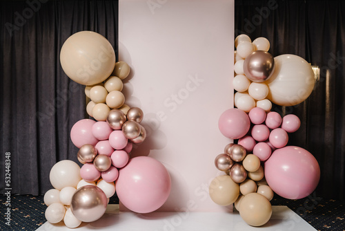 Wedding reception. Arch on background balloons, party decor. Photo-wall decoration space or place with pink, brown, and gold balloons. Trendy autumn decor. Celebration baptism concept. Birthday party.