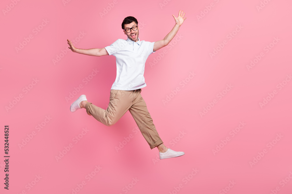 Full length photo of attractive cheerful satisfied man hurry up big black friday sale shopping empty space isolated pink color background Full length photo of attractive cheerful satisfied man hurry up big black friday sale shopping empty space isolated pink color background