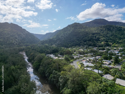 Aerial photo of tropical housing estate in mountain range along a river
