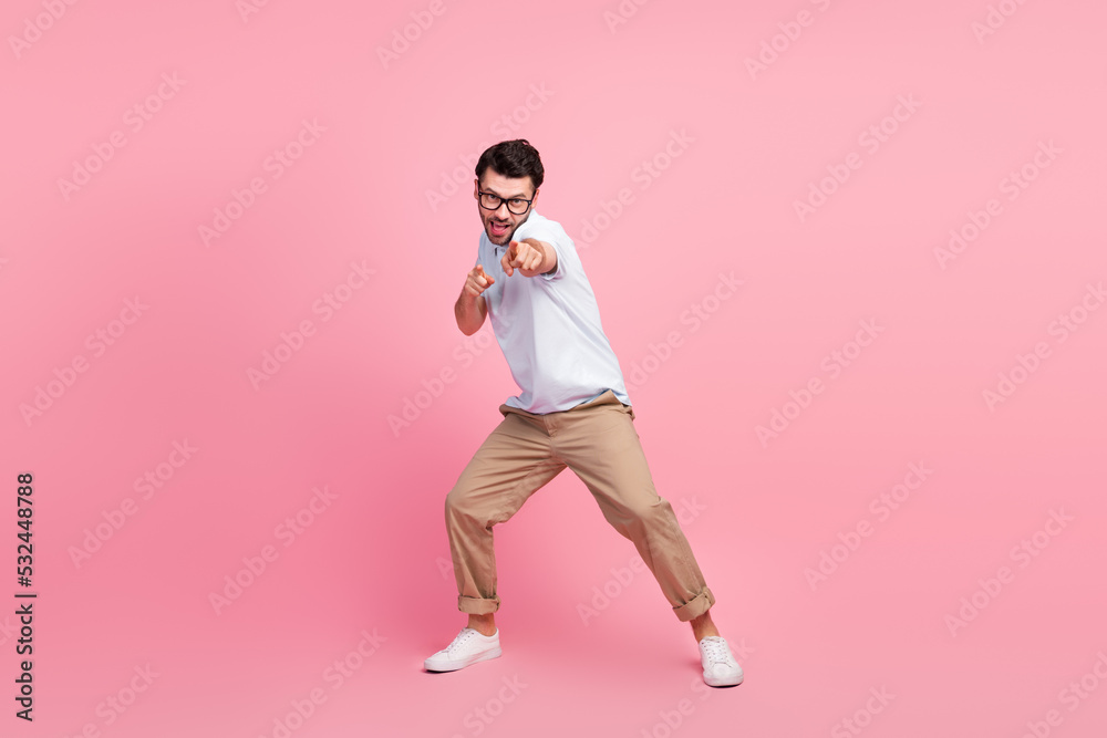 Full length portrait of young successful guy pointing fingers you camera invite meeting date isolated on pink color background Full length portrait of young successful guy pointing fingers you camera invite meeting date isolated on pink color background