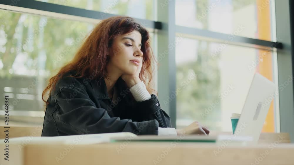 Boring student falling asleep at a desk in the modern library, tired of preparing for the exam, feels exhausted while working on laptop. High quality 4k footage Boring student falling asleep at a desk in the modern library, tired of preparing for the exam, feels exhausted while working on laptop. High quality 4k footage