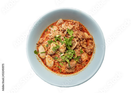 Spicy tom yum rice stick noodles (Thai spicy soup) with braised pork (stewed pork), fresh pork and pork balls sprinkled with coriander in bowl isolated on white background with clipping path. Top view