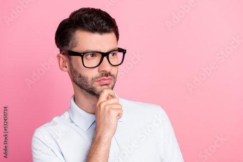 Closeup photo of young attractive handsome bearded guy wear glasses nice hairdo touch chin minded look empty space leader smart isolated on pink color background