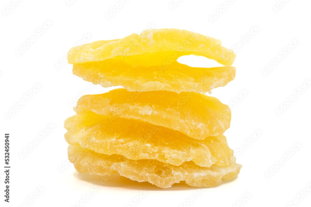 Dried pineapple slice isolated on white background. Dried fruit in sunlight. close up Dried pineapple slice isolated on white background. Dried fruit in sunlight. close up