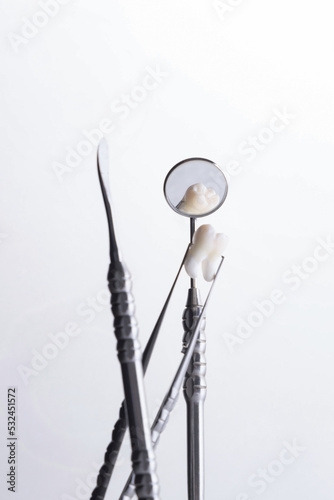Dental instruments used by a dentist in daily practice on a white background