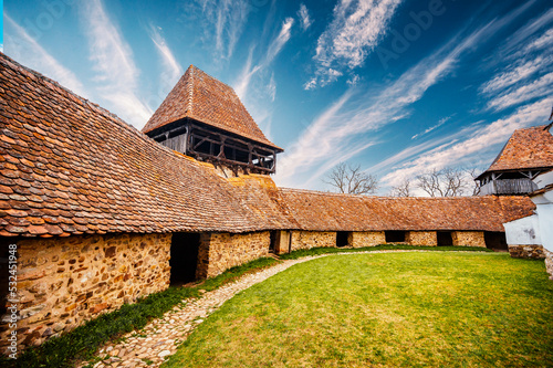 Viscri, Romania: Blue old painted traditional house from village, Transylvania, German Saxon community. Unesco. The Viscri fortified church photo