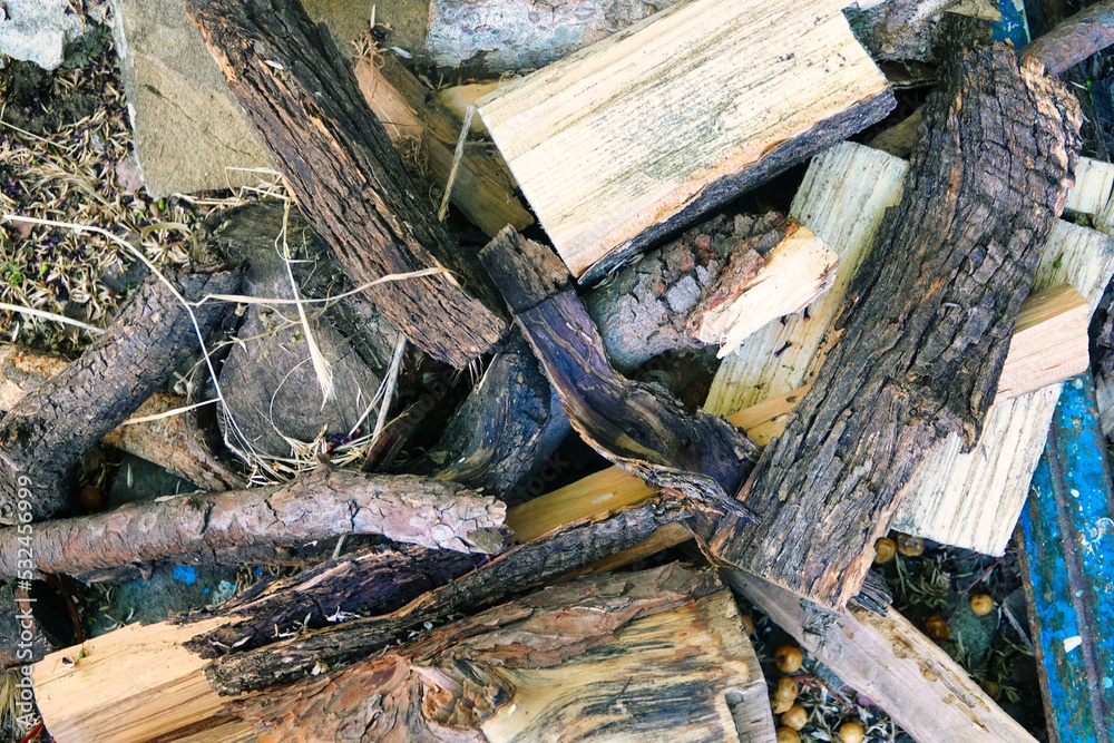 colorful firewood stacks in autumn environment. Pine wood stored for the winter. Cut pine. Eco-friendly wood heating
