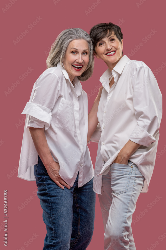 Two well-dressed women looking enjoyed and having fun Two well-dressed women looking enjoyed and having fun