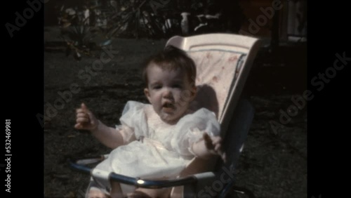 Baby With a Ball 1965 - A baby in a bouncy seat plays with a ball in Canoga Park, California in 1965.  photo