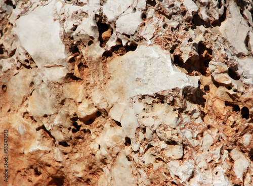 the texture of a mountain brown stone with white veins and hollows
