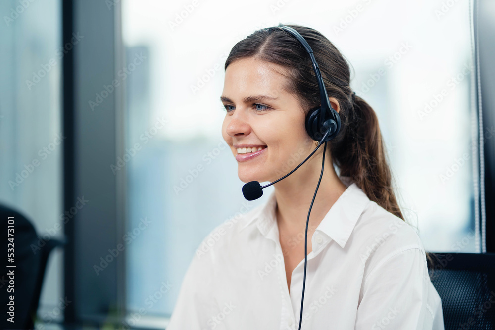 A beautiful woman, a call center representative working in an office. Consulting support while talking to clients via headsets at their desks. Customer service concept. Support, give advice. donations A beautiful woman, a call center representative working in an office. Consulting support while talking to clients via headsets at their desks. Customer service concept. Support, give advice. donations