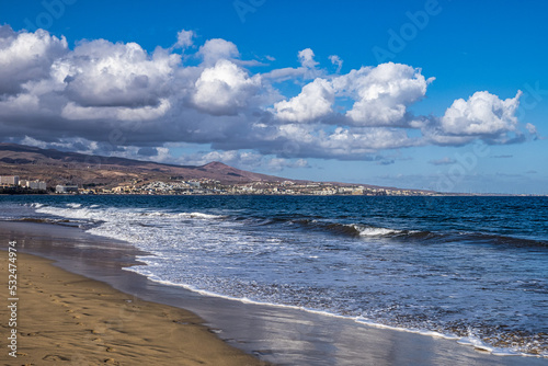 Sandy beach with black stones at Punta de Maspalomas  Gran Canaria  Spain
