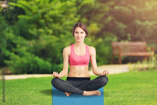Beautiful woman doing yoga relaxed in the park