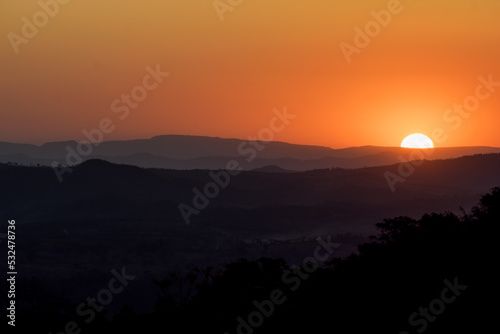 Lindo pôr do sol, sem nuvens e com entardecer de céu dourado e limpo, de cima de montanha no bairro Jardim das Oliveiras, Esmeraldas, Minas Gerais, Brasil