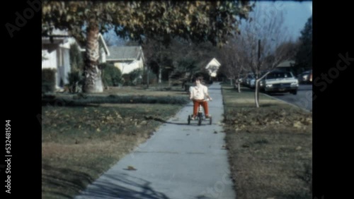 Wallpaper Mural Riding a Tricycle 1967 - A girl rides a tricycle in front of her house in Canoga Park, California in 1967.  Torontodigital.ca