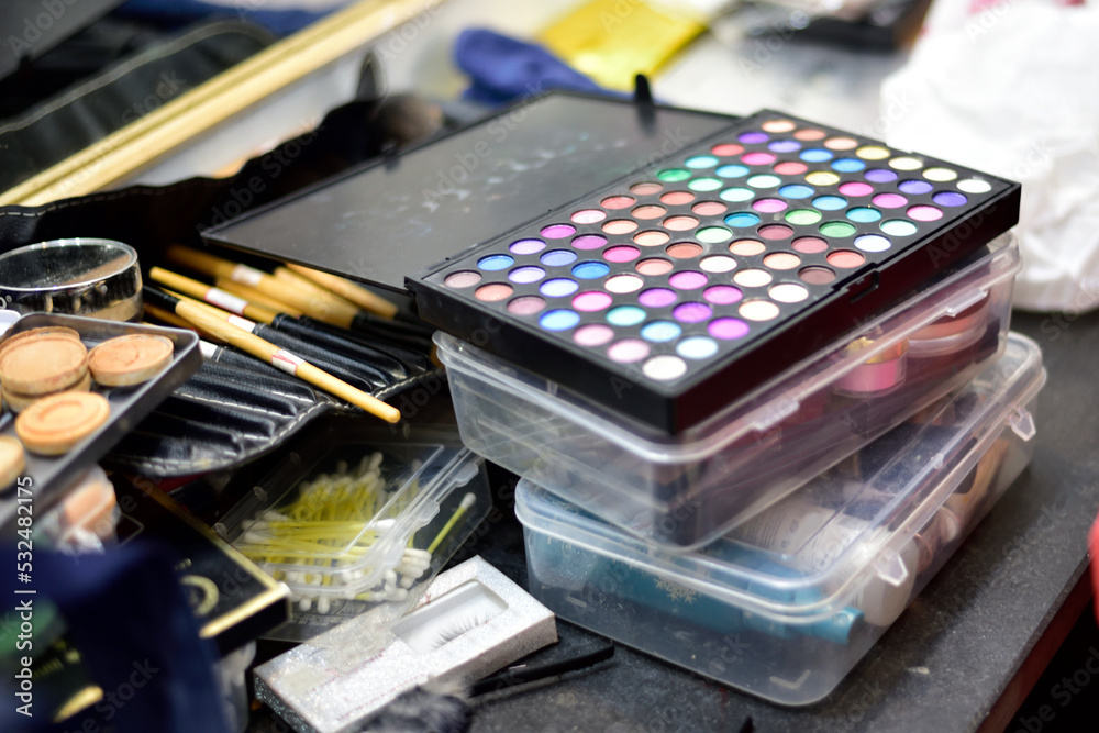 Makeup kits laying down on table haphazardly Makeup kits laying down on table haphazardly