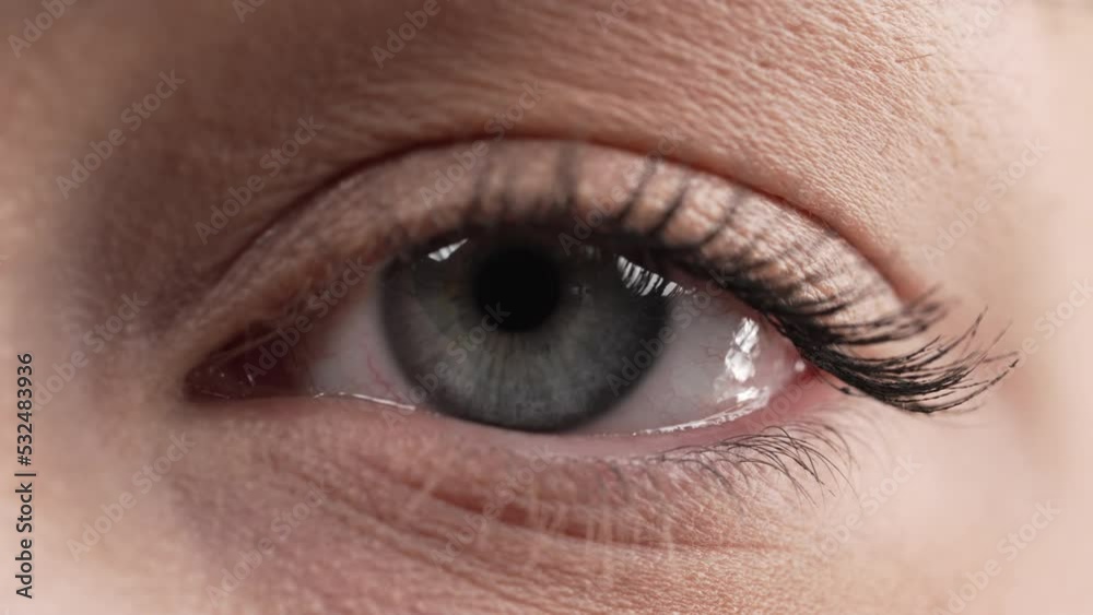 Closeup of a blue-eyed woman's eye, looking from left to right.
