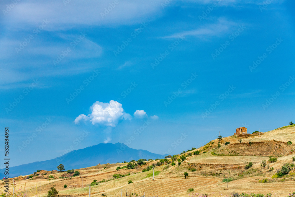 Fototapeta premium An eruption of the Etna volcano on the island Sicily in Italy on a beautiful summer day and a beautiful landscape.