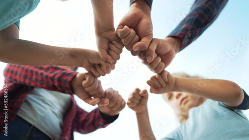 Team of people together in nature. Unity and commonwealth family happiness. Hands in the form of punches are a symbol of teamwork. Family friendship together in nature. Business cooperation concept. photo