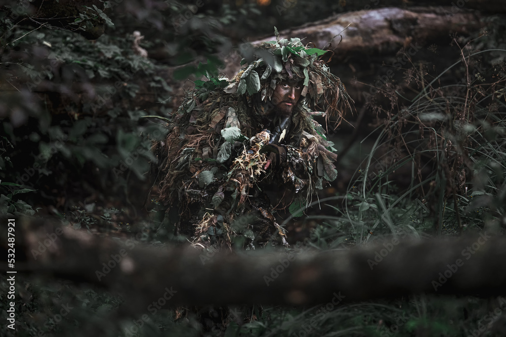 Eastern special forces soldier with rifle in woodland Eastern special forces soldier with rifle in woodland
